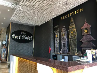 a reception counter with a clock on the wall at The Port Hotel in Istanbul