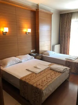 a hotel room with two beds and a window at The Port Hotel in Istanbul