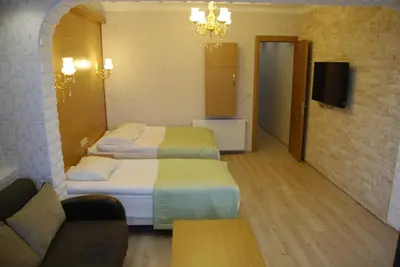 a hotel room with two beds and a couch at The Port Hotel in Istanbul
