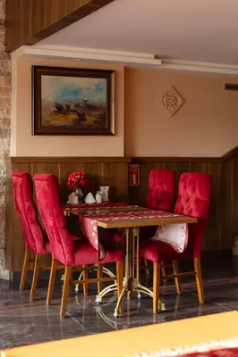 a dining room with a table and red chairs at Classes Hotel Airport in Istanbul