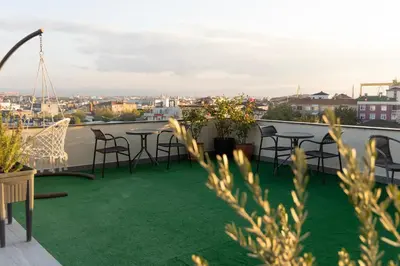 a balcony with tables and chairs on a roof at Classes Hotel Airport in Istanbul