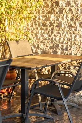 a wooden table and a chair at a table at Classes Hotel Airport in Istanbul