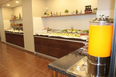a buffet line with a drink on a counter at Hotel Osaka Airport in Istanbul