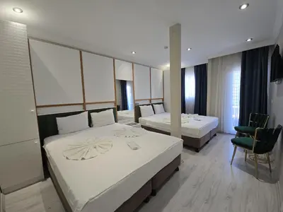 a hotel room with two beds and a chair at The Empress Theodora Hotel ll in Istanbul