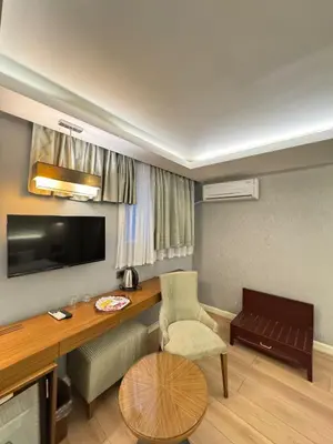 a living room with a desk and a chair at Style Star Hotel Cihangir in Istanbul