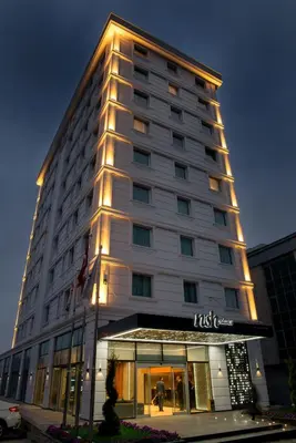 a tall building with a sign on it at Nish Palace Exlusive Suites in Istanbul