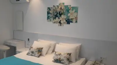 a bedroom with a bed with white sheets and pillows at Payidar HOTEL in Istanbul