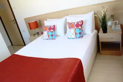 a bedroom with a large white bed with pillows at Payidar HOTEL in Istanbul