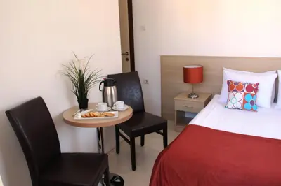 a room with a bed and a table with a coffee maker and a chair at Payidar HOTEL in Istanbul
