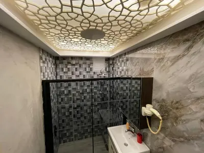 a bathroom with a white sink and a shower at Optimist Hotel in Istanbul