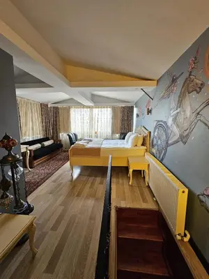 a bedroom with a bed and a living room at Optimist Hotel in Istanbul