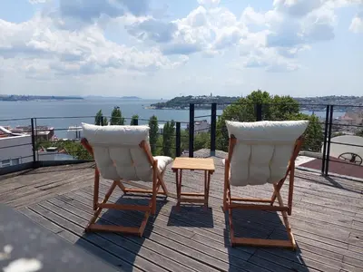 two chairs and a table on top of a deck at Résidence Le Rêve in Istanbul