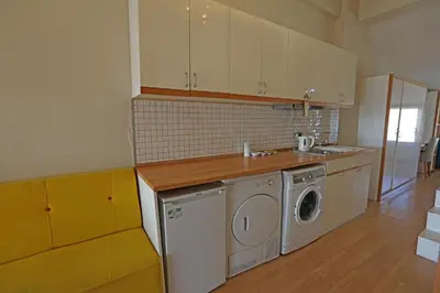a kitchen with a washer and dryer in it at Mezzo Hotel in Istanbul