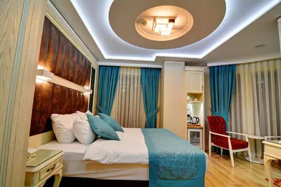 a bedroom with a bed and a desk in a room at Novelty Hotel in Istanbul
