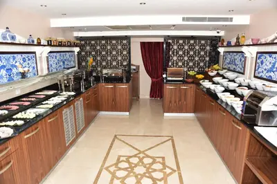 a large kitchen with wooden cabinets and aasteryasteryasteryasteryasteryasteryasteryastery at Neorion Hotel - Special Class in Istanbul