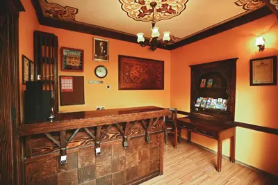 a bar in a room with a clock on the wall at Cheers Vintage Hostel in Istanbul