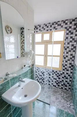 a bathroom with a sink and a mirror at Cheers Vintage Hostel in Istanbul