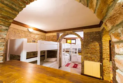 a room with bunk beds in a brick wall at Cheers Vintage Hostel in Istanbul