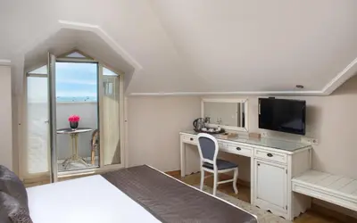 a bedroom with a desk and a tv and a bed at Recital Hotel in Istanbul