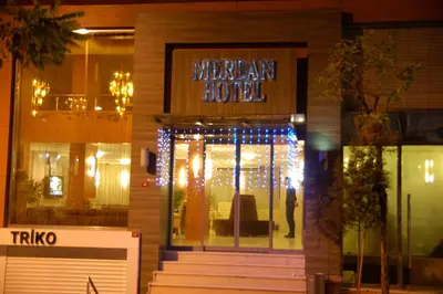 a man standing in front of a hotel with christmas lights at Merdan Hotel in Istanbul