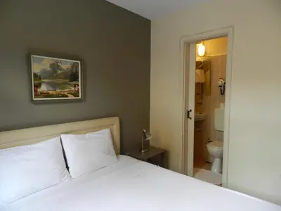 a bedroom with a bed and a bathroom with a toilet at Berk Guest House - Grandma's House in Istanbul