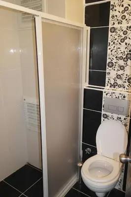 a small bathroom with a toilet and a shower at Istanbul Yildiz Hotel in Marmaraereglisi