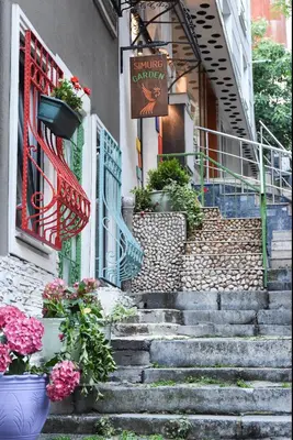 a set of stairs in front of a building with flowers at The Marions Suite istanbul Special Category Taksim in Istanbul