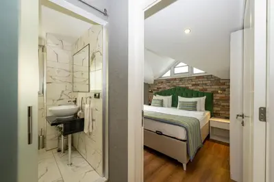 a bathroom with a bed and a sink in a room at The Marions Suite istanbul Special Category Taksim in Istanbul