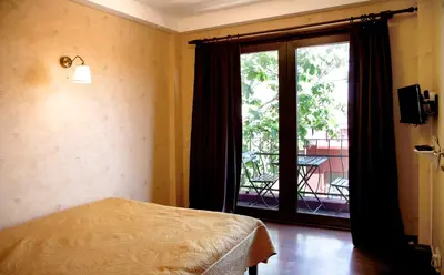 a bedroom with a bed and a large window at L'isola Guesthouse in Heybeliada