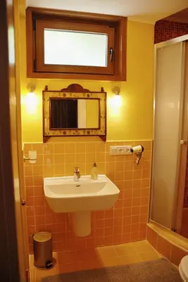 a bathroom with a sink and a mirror at L'isola Guesthouse in Heybeliada