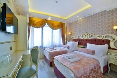 a hotel room with two beds and a television at Nayla Palace Hotel-Special Category in Istanbul