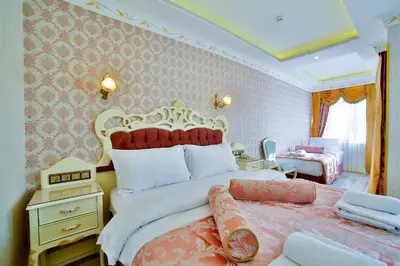 a bedroom with a large bed with a red and white headboard at Nayla Palace Hotel-Special Category in Istanbul