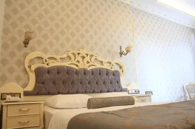 a bedroom with a large bed with a large headboard at Nayla Palace Hotel-Special Category in Istanbul