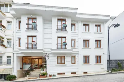 a white building with windows and balconies at Albinas Hotel Old City in Istanbul