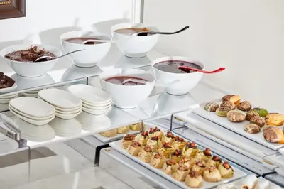 a buffet of food on a table with desserts at Albinas Hotel Old City in Istanbul