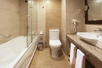 a bathroom with a tub and a toilet and a sink at Arya Hotel Sakarya in Sakarya