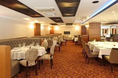 a dining room with white tables and chairs at Arya Hotel Sakarya in Sakarya