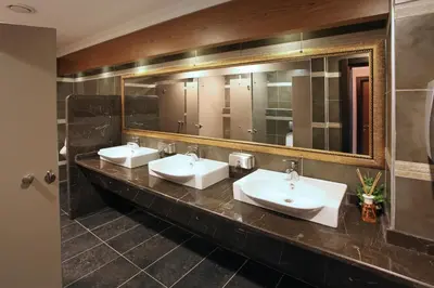 a bathroom with three sinks and a large mirror at Arya Hotel Sakarya in Sakarya