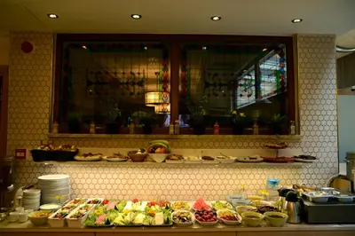 a buffet of food on a counter in a restaurant at Sultans Royal Hotel in Istanbul