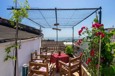 a table and chairs on a balcony with roses at Gedikpasa Konagi Hotel in Istanbul