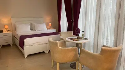 a bedroom with a bed and a table and chairs at Chez Bore in Istanbul
