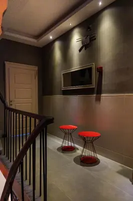a staircase with two red tables in a room at Cheers Porthouse in Istanbul