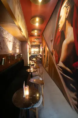 a restaurant with tables and a painting on the wall at Cheers Porthouse in Istanbul