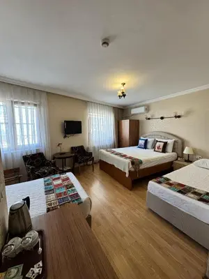 a hotel room with two beds and a couch at Hotel Ipekyolu in Istanbul