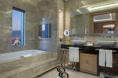a bathroom with two sinks and a bath tub at Hilton Bursa Convention Center & Spa in Bursa