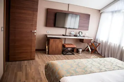 a hotel room with a bed and a desk and a television at Old Port Hotel in Istanbul