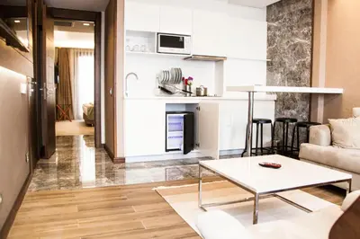 a living room with a table and a kitchen at Old Port Hotel in Istanbul