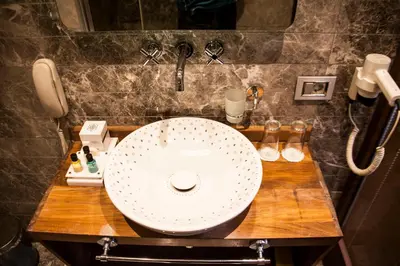 a bathroom with a white sink and a phone at Old Port Hotel in Istanbul