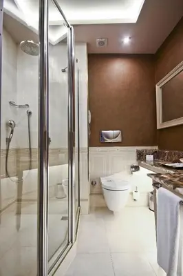 a bathroom with a toilet and a glass shower at Fuat Pasa Oteli - Special Category Bosphorus in Istanbul