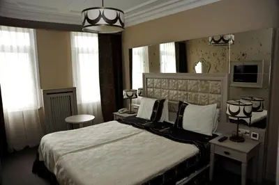 a bedroom with a bed and a large mirror at Fuat Pasa Oteli - Special Category Bosphorus in Istanbul